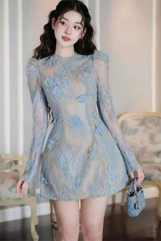 Woman wearing a light blue lace dress in an indoor setting