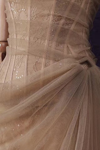 Mannequin wearing a beige lace dress against a purple textured wall with 'Alexander Charlie' branding.