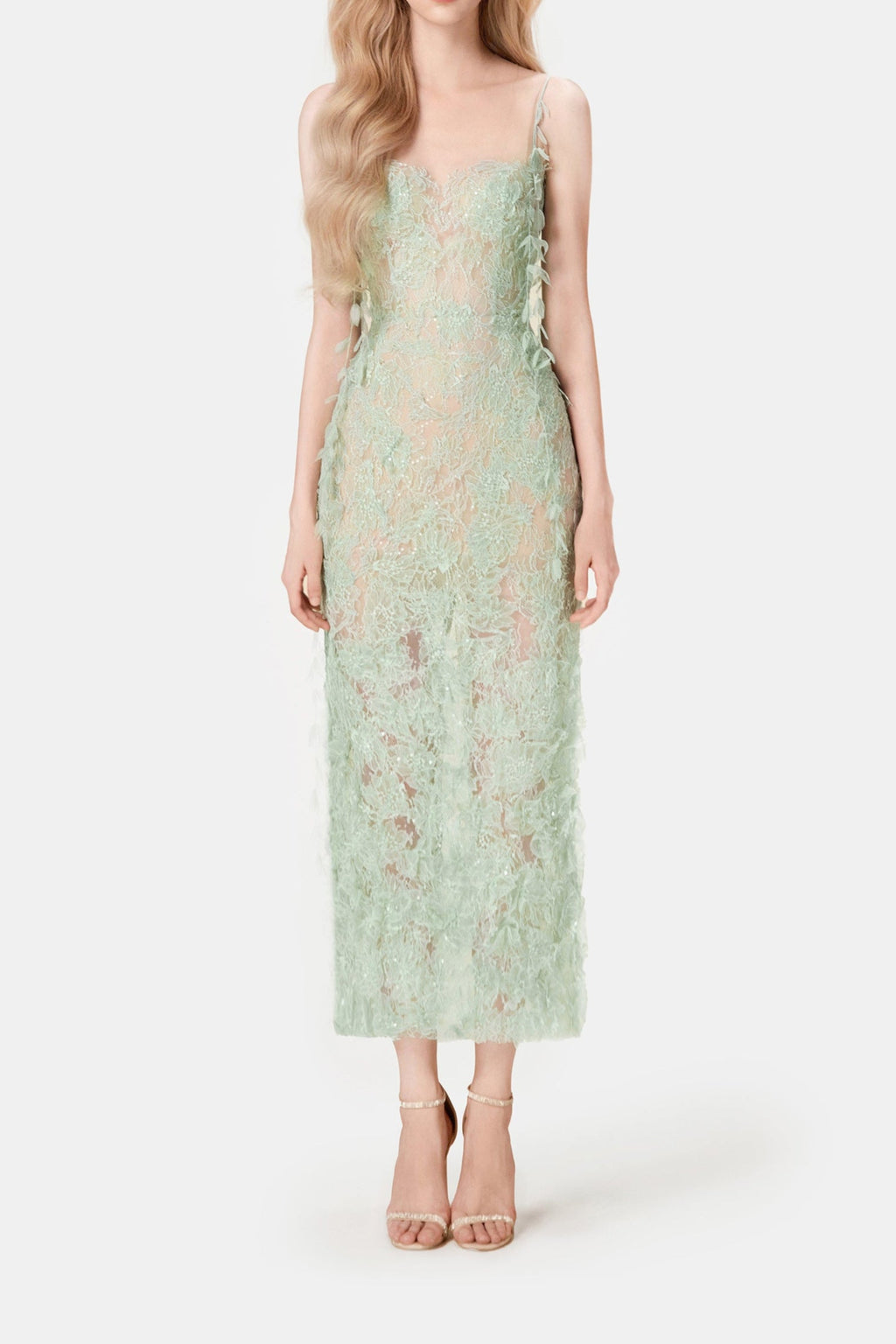 Woman wearing a light green lace dress on a white background