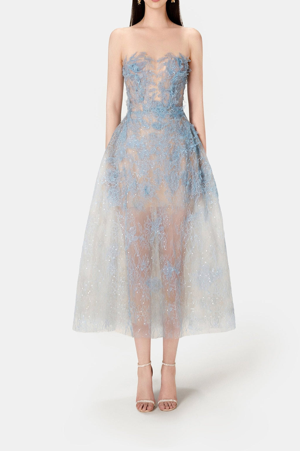A model wearing a blue beaded lace mini dress with a fitted bodice and flowing skirt, standing against a white background.