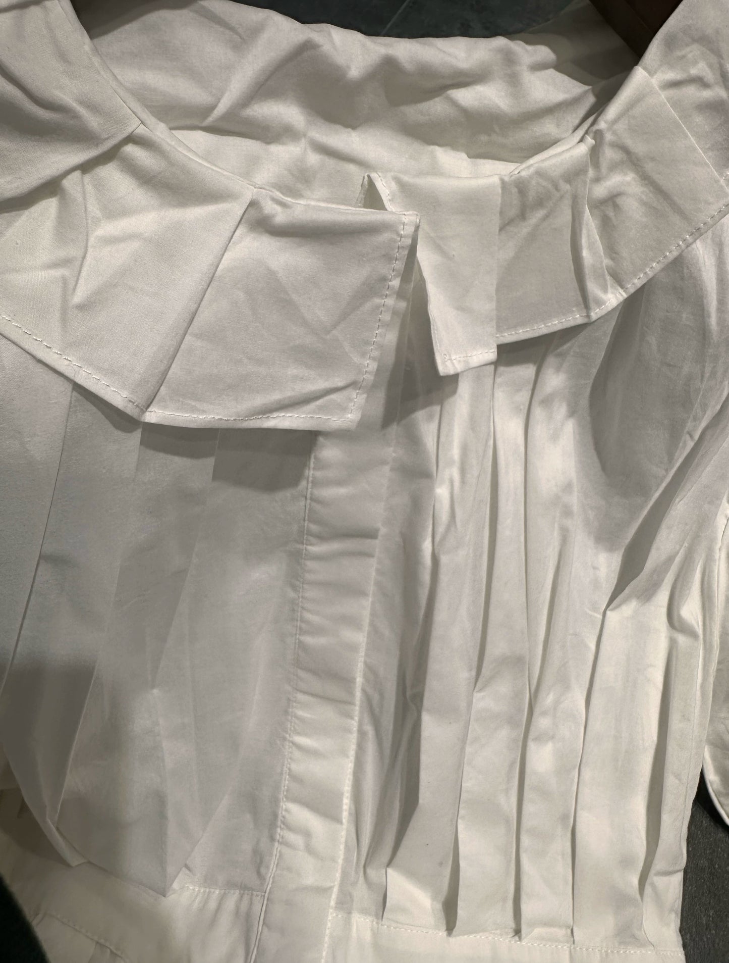 white midi dress with a crew neck and pleated lantern sleeves