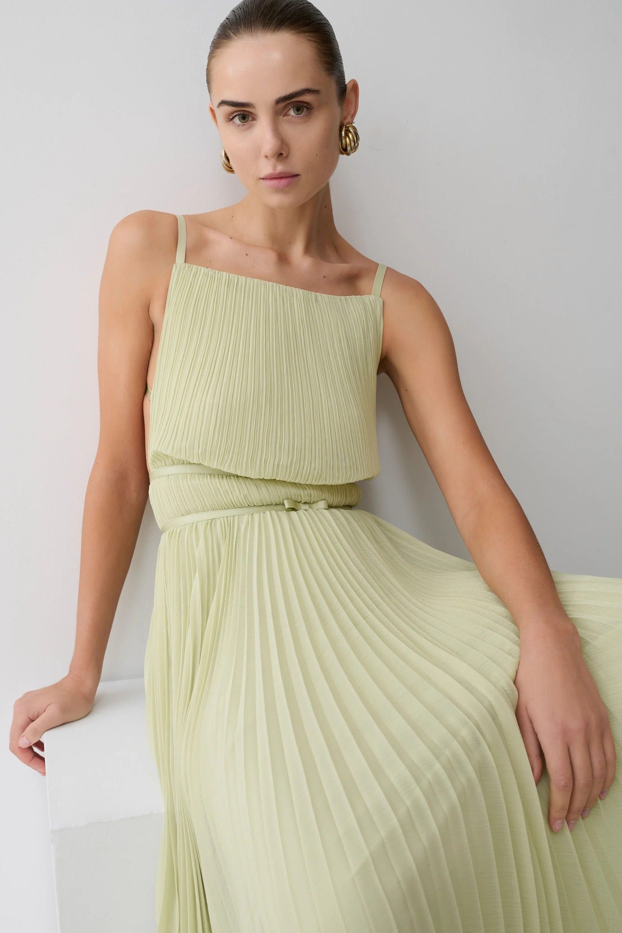 yellow pleated cinched backless slip dress