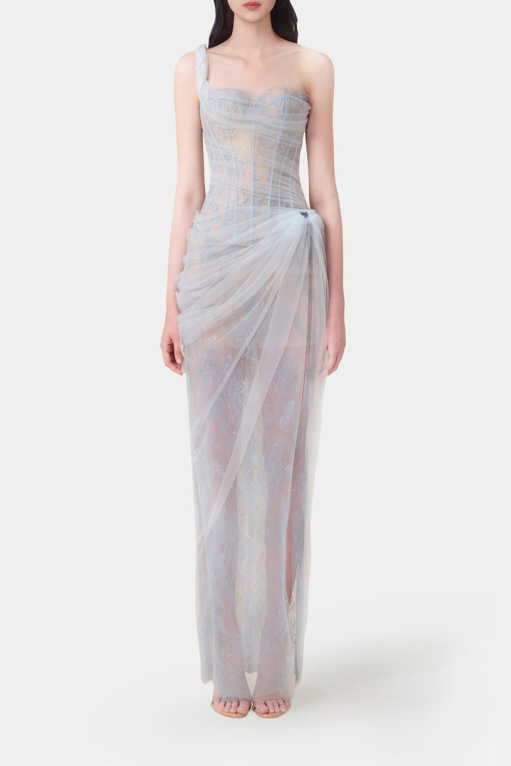 Woman wearing a light blue strapless gown on a white background
